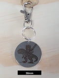 Muffin on his T-Rex Engraved Fob